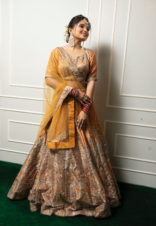 The mustard-colored lehenga features exquisite handwork