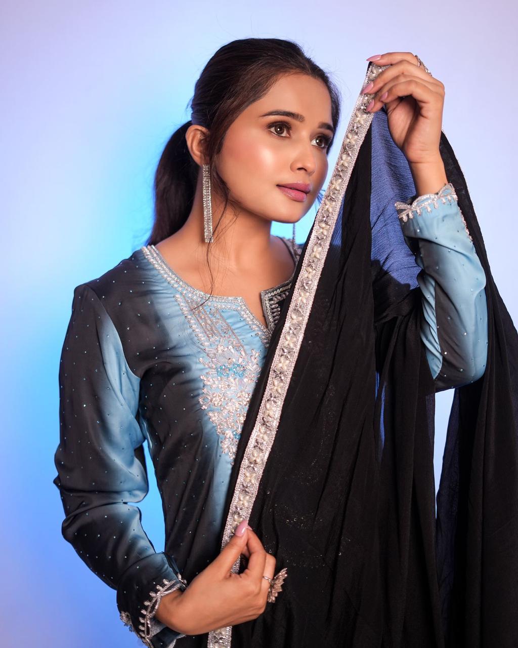 The black and sky blue double-shaded Pakistani suit features exquisite handwork