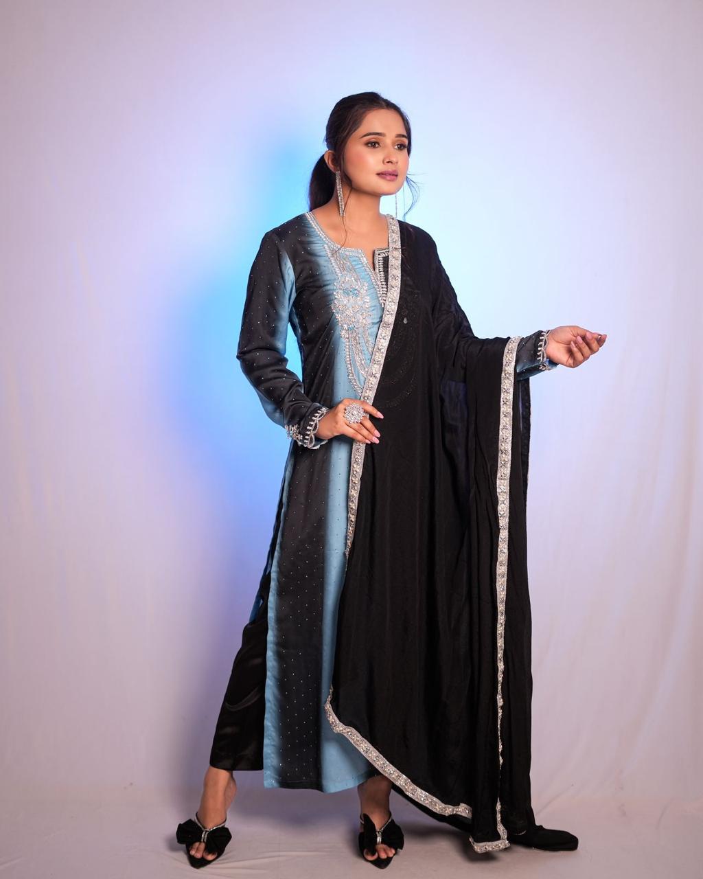 The black and sky blue double-shaded Pakistani suit features exquisite handwork