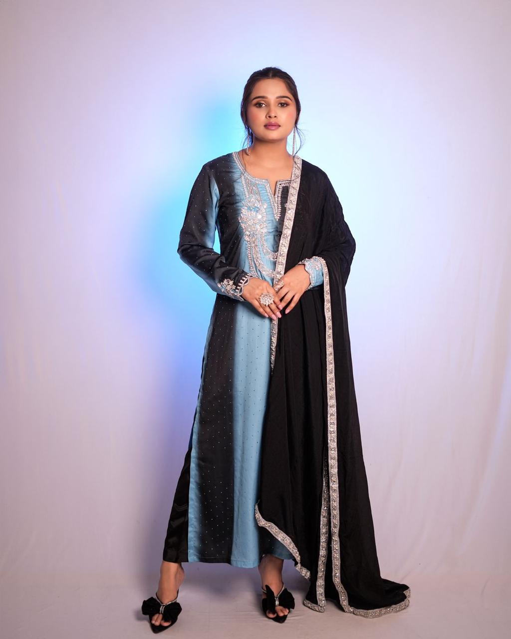 The black and sky blue double-shaded Pakistani suit features exquisite handwork